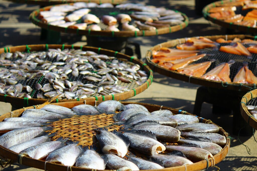 It is a type of curing that flavors, browns, cooks, and preserves food by exposing it from burning wood