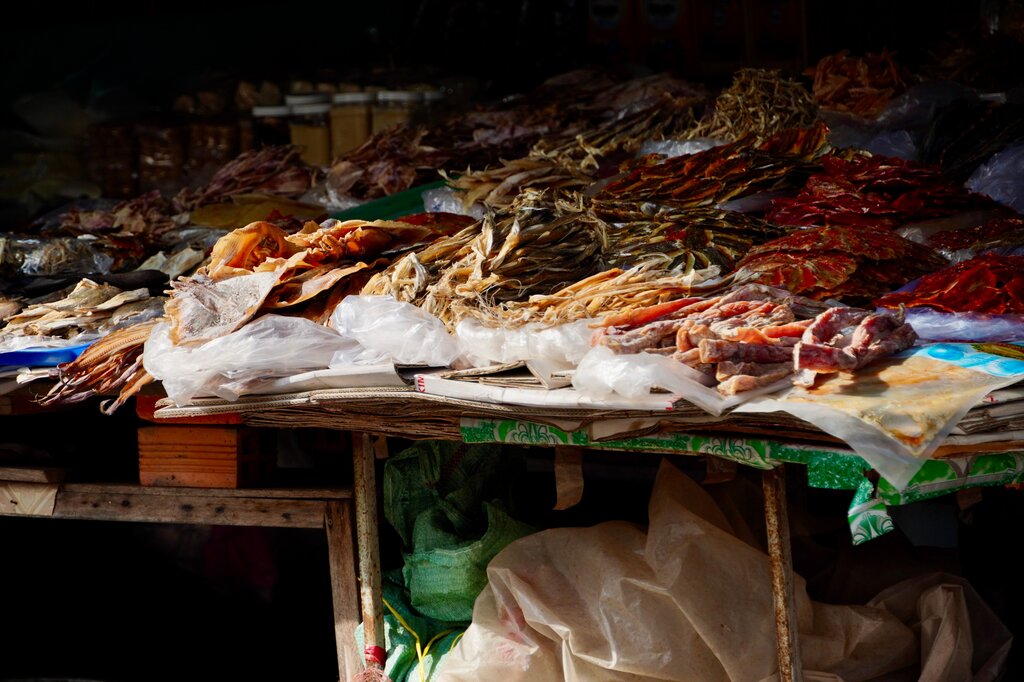 It is a traditional preservation method predating refrigerator, draws water  out of food to prevent bacterial growth