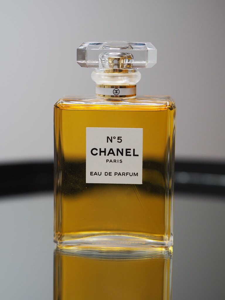 Chanel No. 5's rectangular bottle broke tradition in 1921 because it was:
