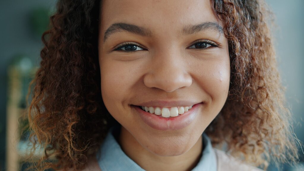 This round shows a person smiling with bright eyes. Which feeling is most likely shown?