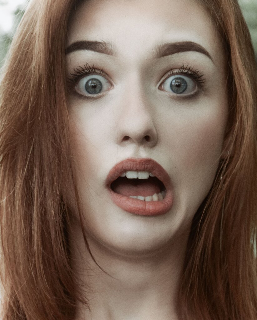 A face with wide eyes and open mouth shows which feeling?