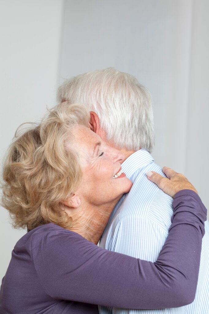 A warm hug and gentle smile appear in the picture. What feeling is shown?