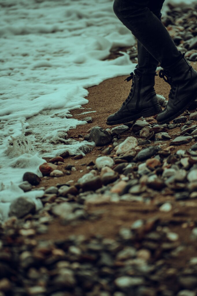 You are walking on wet rocks at the beach.